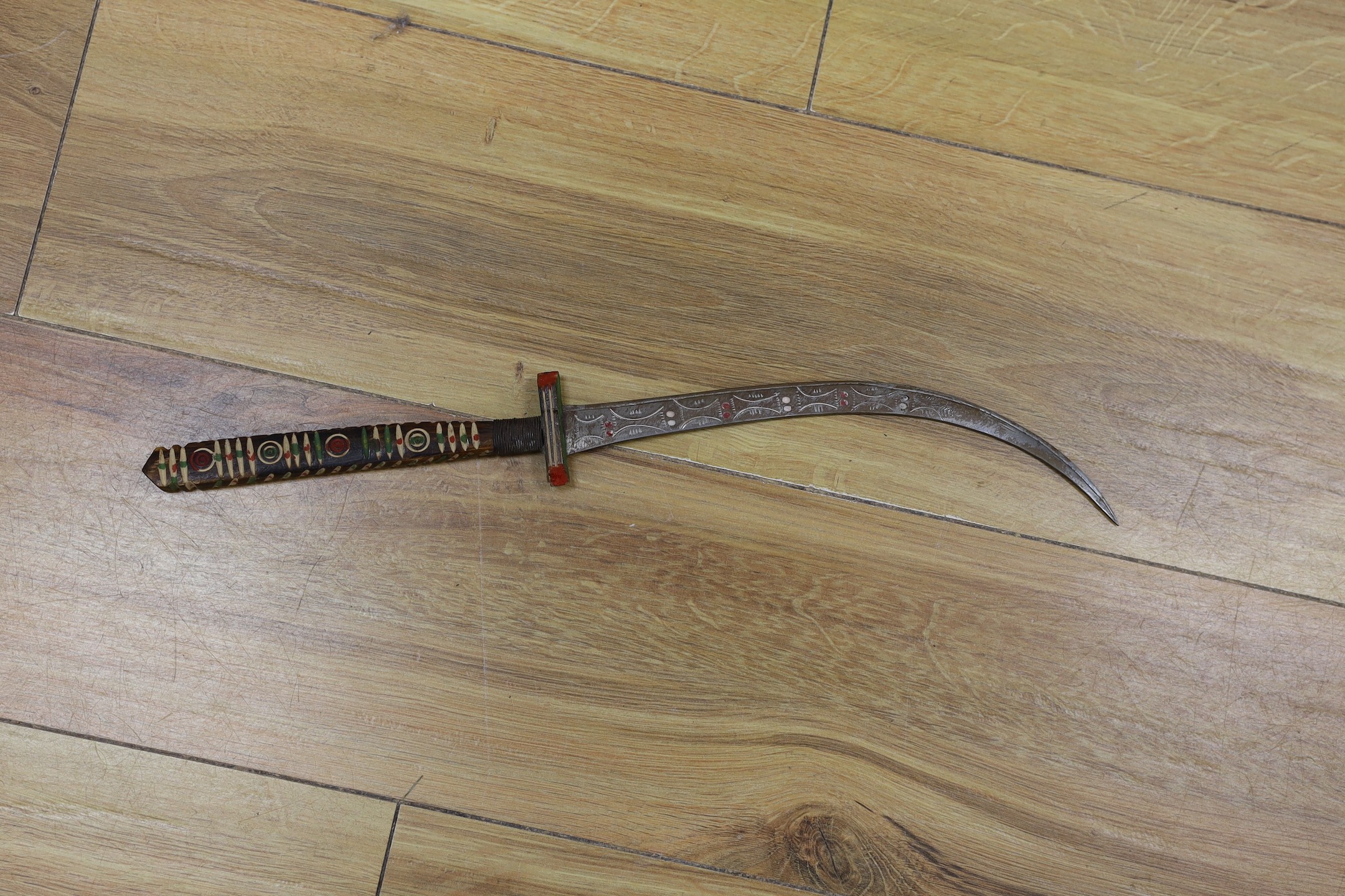 A George V military dress sword in brown leather covered scabbard, 102cm long, and a Middle Eastern dagger with carved and painted handle